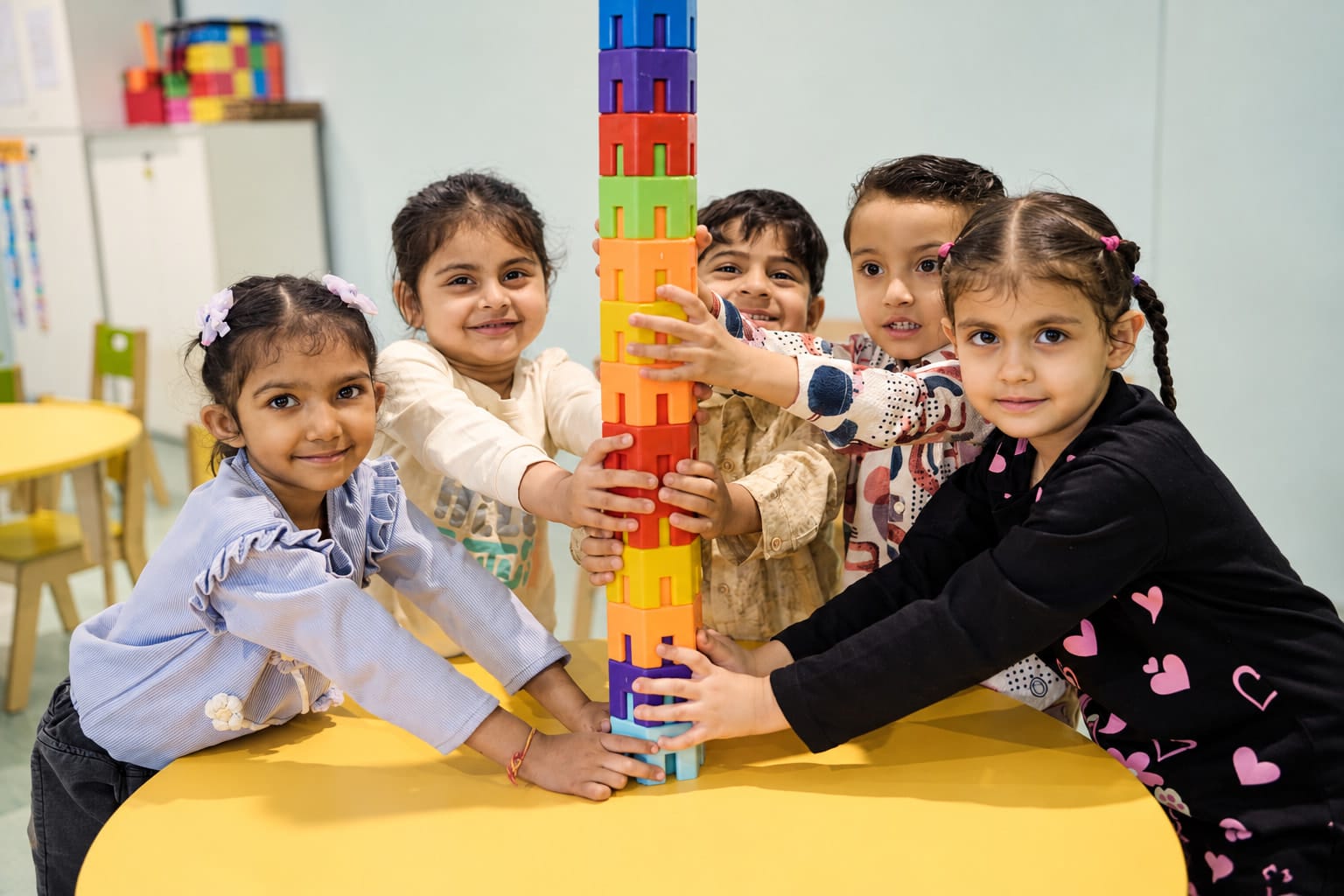 Children building a tower of blocks together
