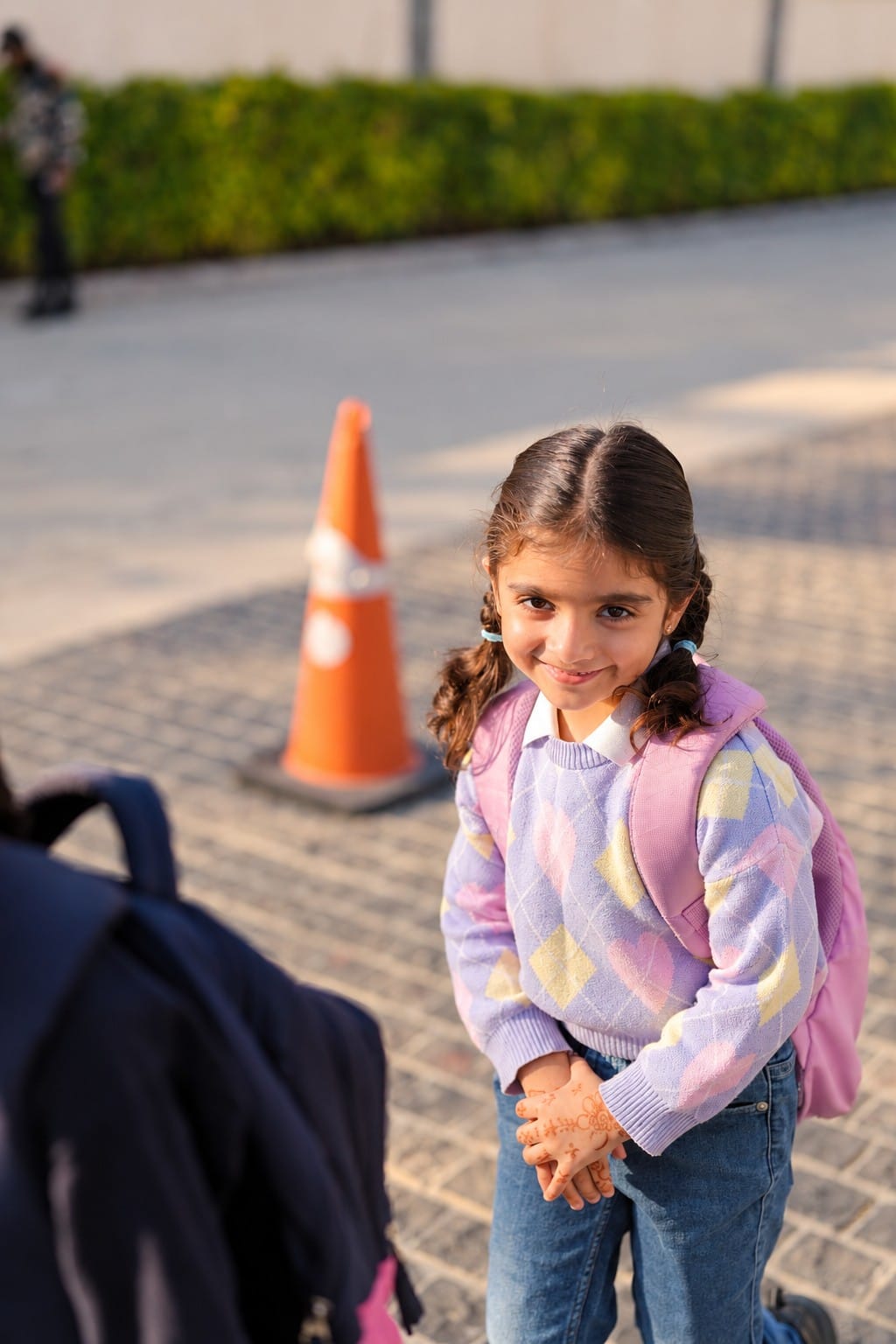 A little girl with her school bag on the way in