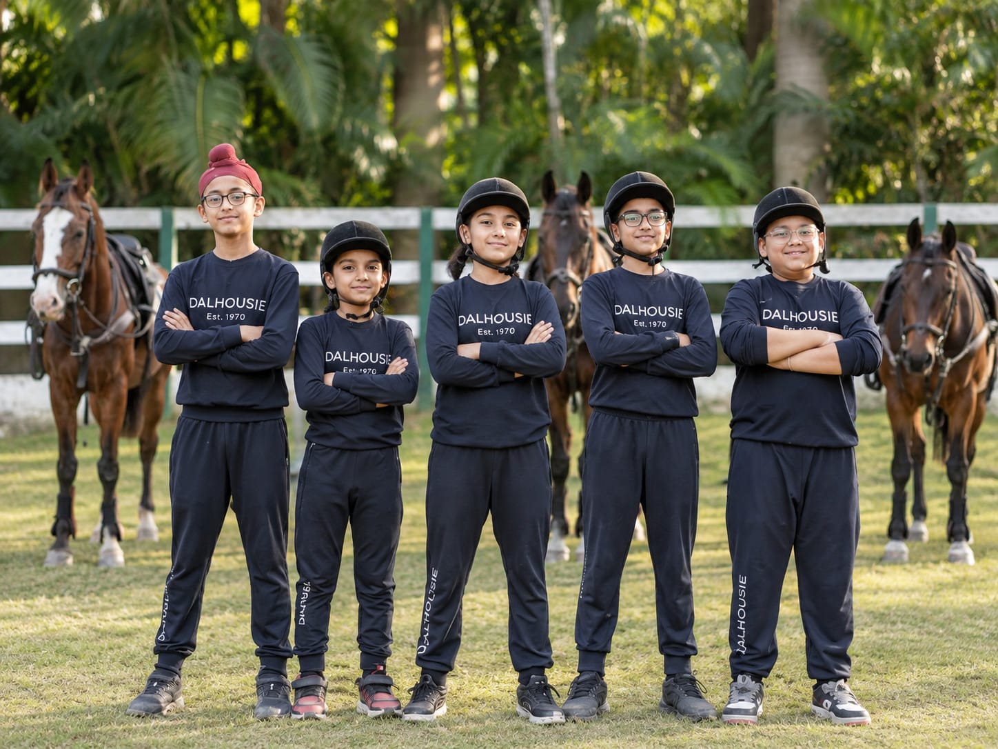 Primary students in riding kit with the horses